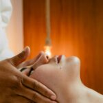 A peaceful facial massage in a warm spa environment, promoting relaxation and wellness.